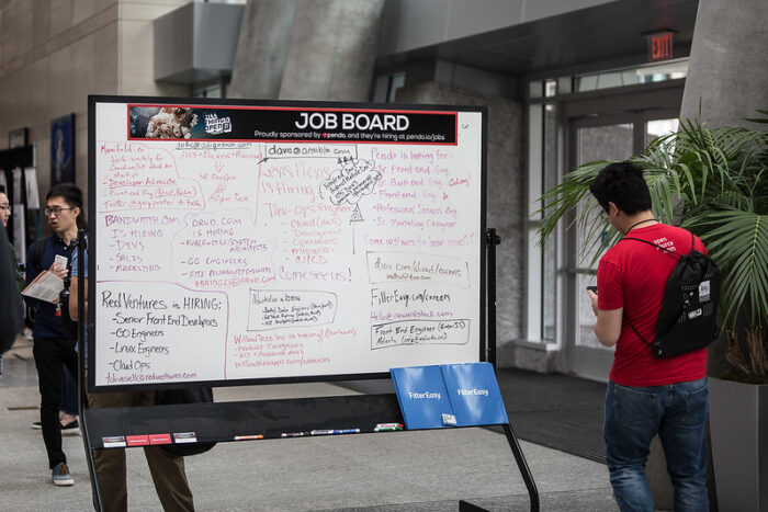 Dry erase job board in the central registration area at All Things Open 2017.