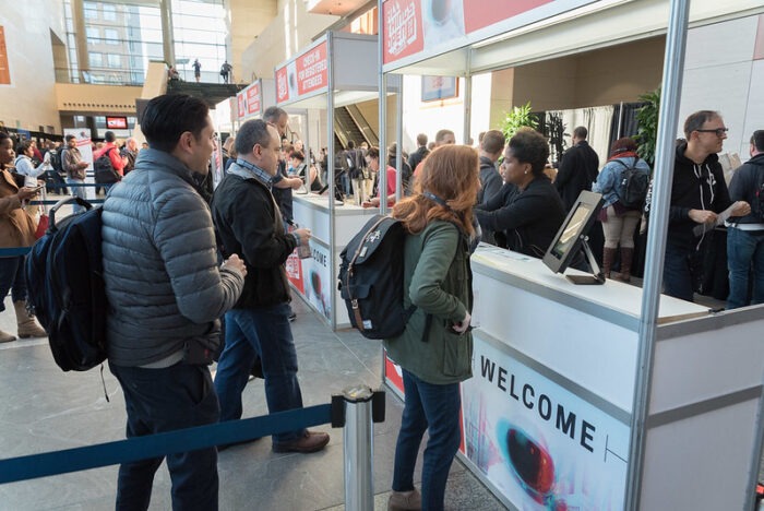 The well organized registration system required the use of several booths.