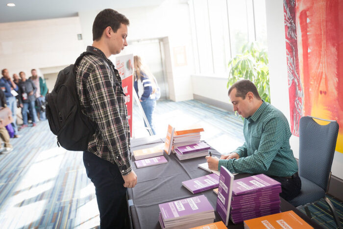 Writer Andreas Antonopoulos signing copies of his The Internet of Money books.