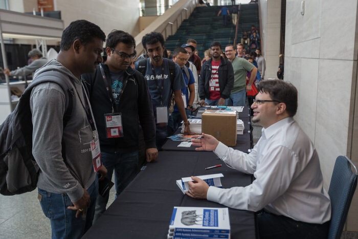 Writer Federico Lucifredi signing copies of his book "AWS System Administration" at All Things Open 2018.