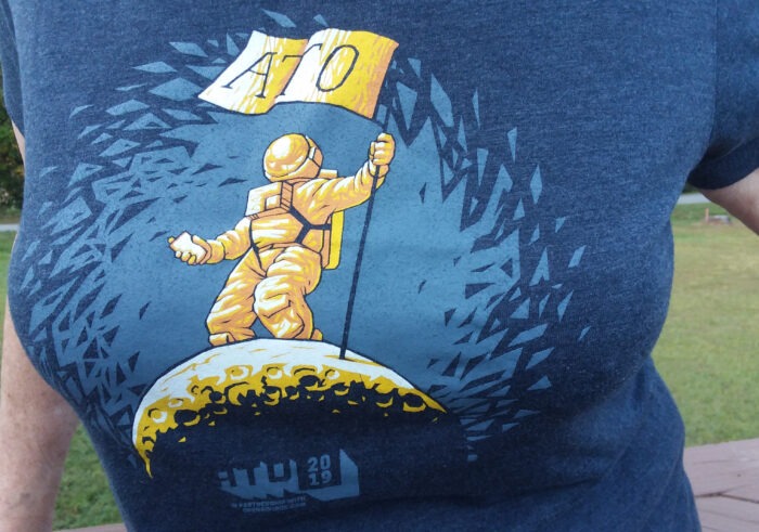 ATO's 2019 t-shirt shows the spaceman planting the ATO flag on the moon.