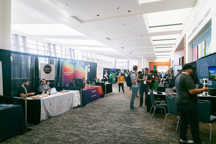 People visiting vendor booths at All Things Open 2022.