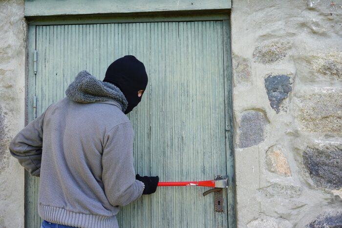 Thief forcing door open.
