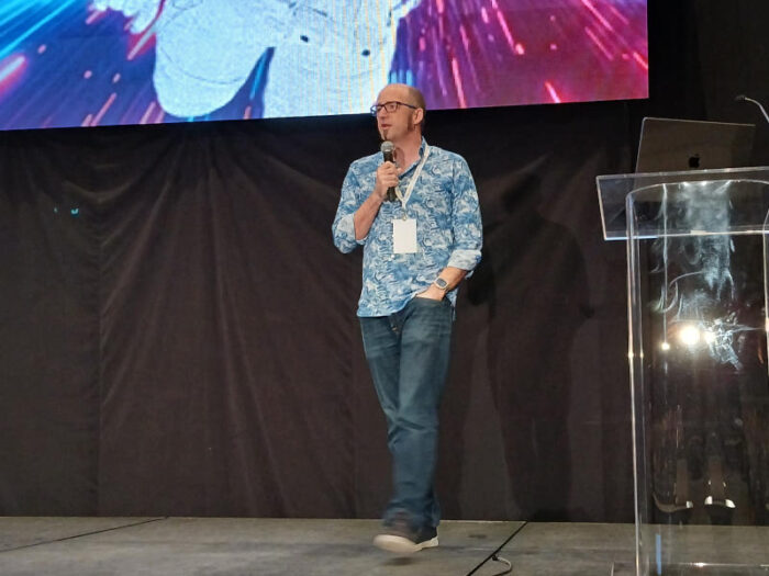 Emcee Jono Bacon during the keynotes on All Things Open's second day.