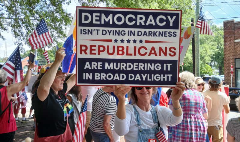 Elkin, No Kings protest, "Democracy doesn't die in darkness" sign.