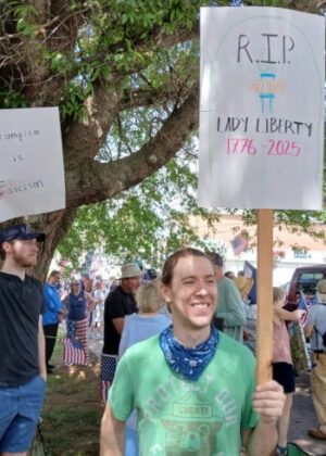 Younger dude holding a sign at Elkin No Kings event.