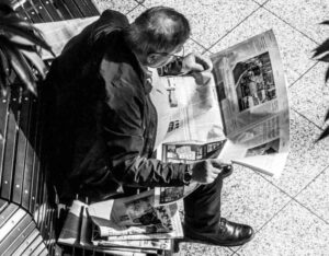 Man reading a newspaper.